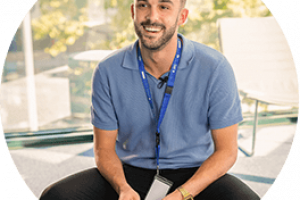 person with badge sitting
